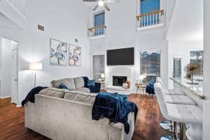 a living room with a couch and a tv at Game Room, Crib, Fenced Backyard, Relocation Stay in Frisco