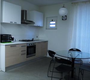 a kitchen with a table and a table and chairs at Residence "I Centralissimi Mamiblu' " in Vasto