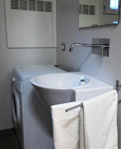 a bathroom with a sink and a washing machine at Residence "I Centralissimi Mamiblu' " in Vasto +39 photos