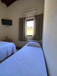 Cama ou camas em um quarto em Pousada Kembali Maresias