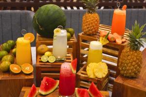 a display of fruit and candles with fruits and vegetables at Azana Garden Hill Resort Blora in Blora