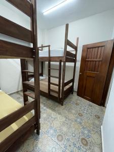 En eller flere senge i et værelse på My Family In Merida Hostel