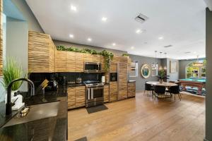 a kitchen and dining room with a table and a dining room at Miami Gucci Home with Pool & Great Location in Miami