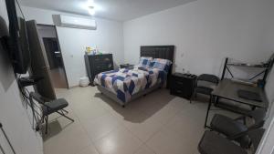 a bedroom with a bed and a table and chairs at Everest 663 in Monterrey