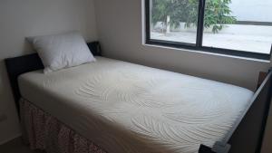 a small bed in a room with a window at Everest 663 in Monterrey