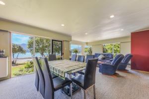 a dining room with a table and chairs at Linkwater Wonder - Marlborough Holiday Home in Picton