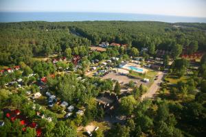 an aerial view of a parking lot in a forest at Holiday Resort & Camping InterCamp'84 in Łeba