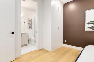 a white bathroom with a toilet and a sink at Long Stays, Pets Welcome, Free Parking & King Bed in Calgary +15 photos