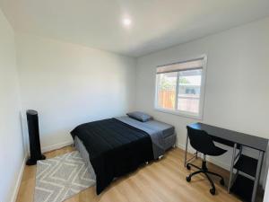 a bedroom with a bed and a desk and a computer at Cozy home Bay Area ROOM 2 in San Jose