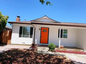 a white house with an orange door at Cozy home Bay Area ROOM 2 in San Jose
