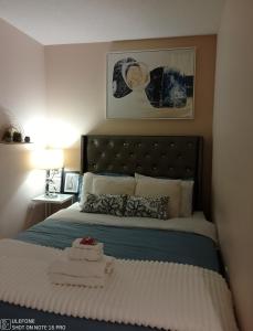 a bedroom with a bed with a blue comforter at Downtown Toronto Condo Suite in Toronto