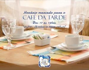 a table with plates and glasses on a table at Quinta Brasilis Boutique Hotel Paraty in Paraty