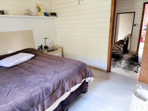 a bedroom with a bed and a door to a garage at Casa de Campo em Gramado in Gramado +18 photos