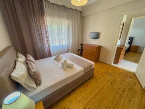 a bedroom with a bed with two towels on it at Sivi's Vacation Homes in Skala Kallirachis