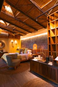 a bedroom with a bed and a desk with a chair at awā Beachfront Hotel in Puerto Viejo