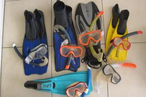 a group of pairs of goggles and pairs of scissors at L'Îlot de la Marina in Le Marin