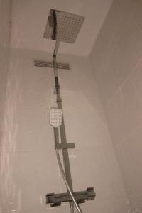 a shower head on the ceiling of a bathroom at L'Îlot de la Marina in Le Marin +9 photos