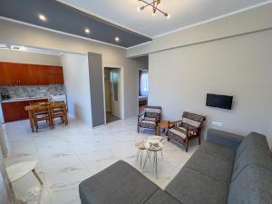 a living room with a couch and a table at Sivi's Vacation Homes in Skala Kallirachis