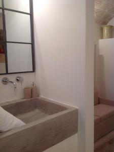 a bathroom with a bath tub with a mirror at L' Edera in Fasano
