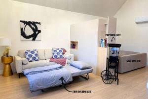 a living room with a couch and a table at Hollywood Family Nest in Burbank, Steps to Studios! in Burbank