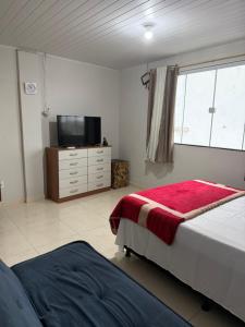 Ένα ή περισσότερα κρεβάτια σε δωμάτιο στο Casa Kitnet para casal