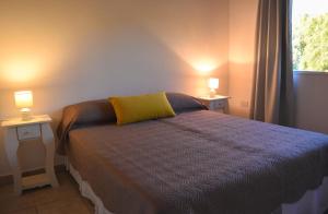 En eller flere senge i et værelse på Apart Punto Norte