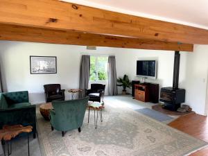 a living room with a wood stove and chairs at Howard's Mountain Lodge in National Park