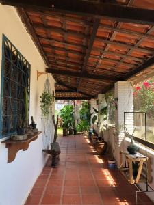 a hallway with potted plants and a wooden ceiling at Hostel 35 in Aracati