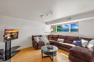 a living room with a couch and a table at Modern and Relaxing Lake Sammamish View House in Issaquah