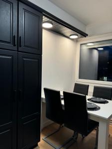 a conference room with a table and chairs and a window at Le 9 - Basel Airport in Saint-Louis