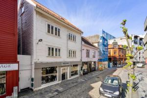a small car parked in a street with buildings at Stavanger Sea 1 Ultra Central Dali Apartament General Shop Open 7 l 7 in Stavanger