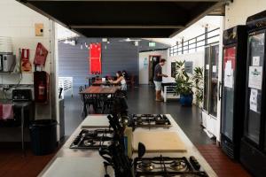 a kitchen with a bunch of stove tops at Youth Shack Backpackers Darwin in Darwin