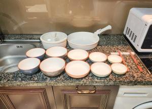 a kitchen counter with four bowls and a sink at Yeoksam Artnouveau City Hotel and Residence in Seoul