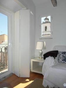 a bedroom with a bed and a table with a lamp at River View Penthouse in Lisbon +46 photos