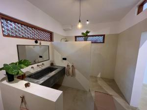 a bathroom with a sink and a large mirror at Charleston's Ahangama in Ahangama +61 photos