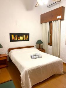 una camera da letto con un grande letto bianco in una stanza di Hotel Centro a Piriápolis