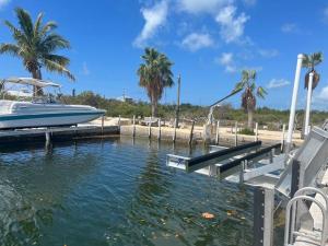 a boat is docked at a dock next to a beach at Beach View Room at Barnacle Resort in Big Pine Key