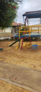 a yellow and blue playground in the sand at Condomínio São Francisco in Petrolina