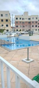 a swimming pool with blue water in front of a building at Condomínio São Francisco in Petrolina