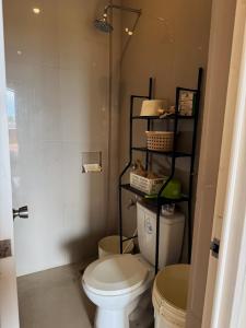 a small bathroom with a toilet and a shower at Viewleaf Resort Hotel in Marikina