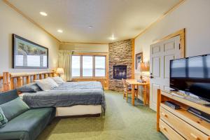 a bedroom with a bed and a flat screen tv at Pool and Lake Access Northern Lakes Retreat! in Two Harbors