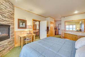 a bedroom with a bed and a bathroom with a tub at Pool and Lake Access Northern Lakes Retreat! in Two Harbors