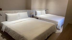 Postel nebo postele na pokoji v ubytování 衿后禾居Good Hotel