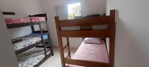a room with two bunk beds and a window at Casa de praia in Praia Grande +42 photos
