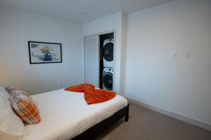 a bedroom with a bed and a tv in the corner at Beehive Haven in Salt Lake City