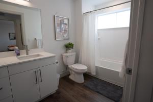 a bathroom with a toilet and a sink and a window at Beehive Haven in Salt Lake City +21 photos