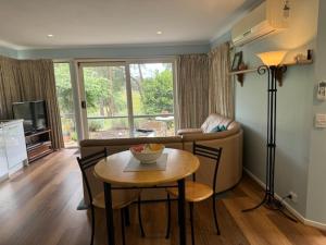 a living room with a table and a couch at Countryside Retreat romantic tranquil native wildlife township Hepburn - Daylesford in Hepburn Springs