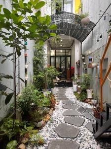 a walkway in a building with plants and rocks at 1979 Homestay 2 in Hue