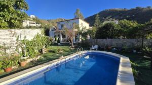 a swimming pool in the yard of a house at Casa Luis in Viñuela