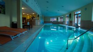 a large swimming pool in a hotel room at Sojka Resort - Hotel & Drevenice in Bešeňová